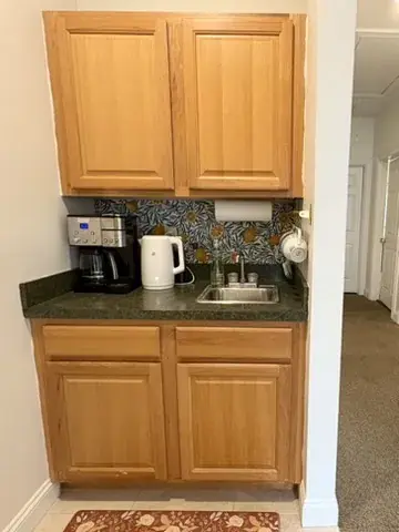 Full kitchen with refrigerator and microwave for therapy office tenants